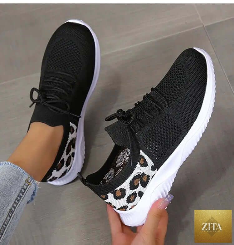 White women's leopard print lace-up sneakers from SnagBag, designed for sports and casual wear.