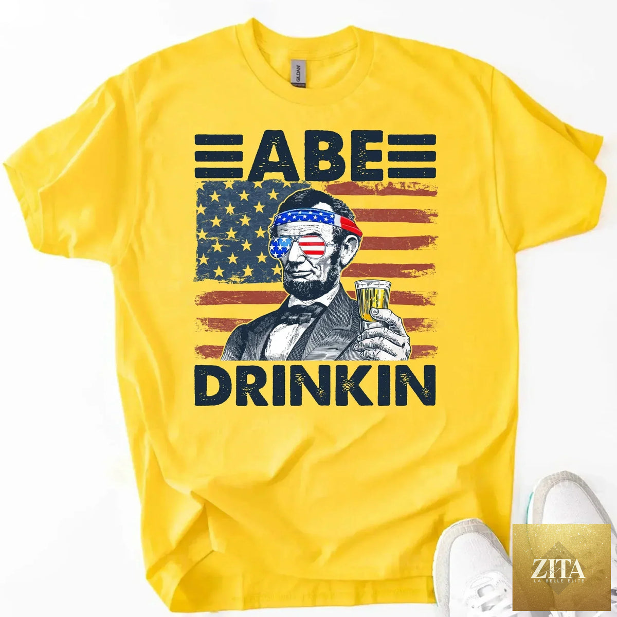 Abraham Lincoln patriotic drinking T-shirt featuring 4th of July design, from Adorb Custom Tees, with festive red, white, and blue colors.