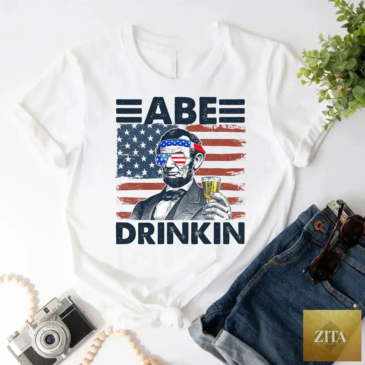 Abraham Lincoln patriotic T-shirt featuring a humorous 4th of July drinking design, ideal for patriotic celebrations.
