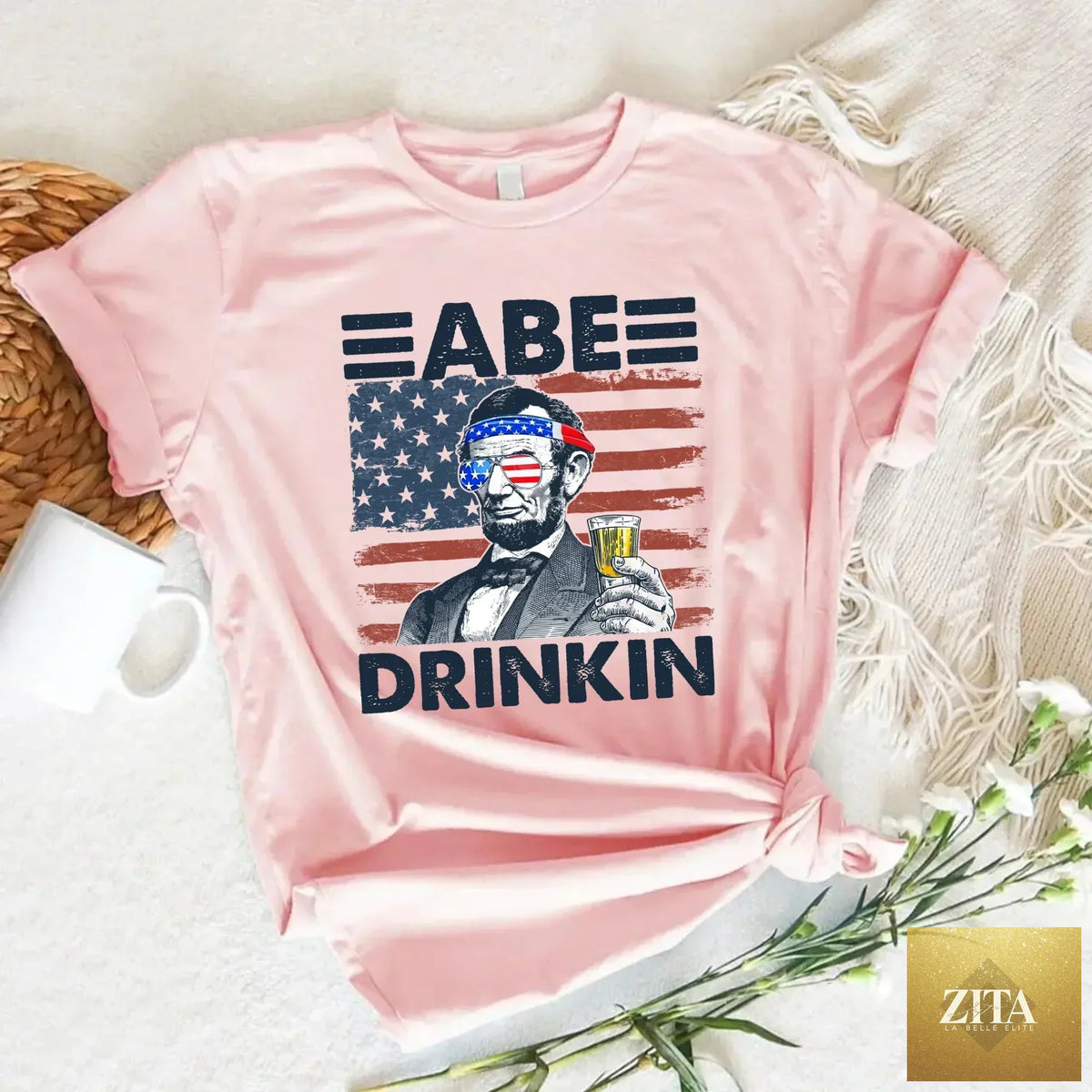 A patriotic Abraham Lincoln T-shirt featuring a drinking theme for 4th of July, with a vintage style design.