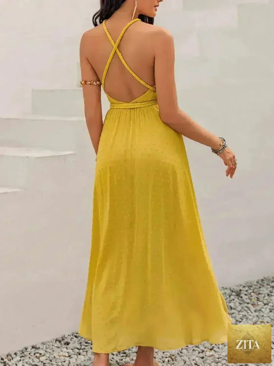 Femstylo women's Swiss Dot backless dress with tied detail and flowing silhouette, showcasing a stylish, elegant backless design.