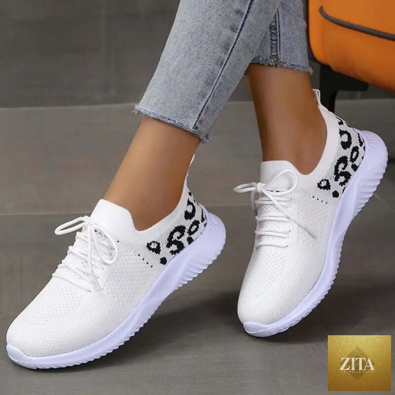 White women’s leopard print lace-up sneakers by SnagBag, designed for sports and casual wear.