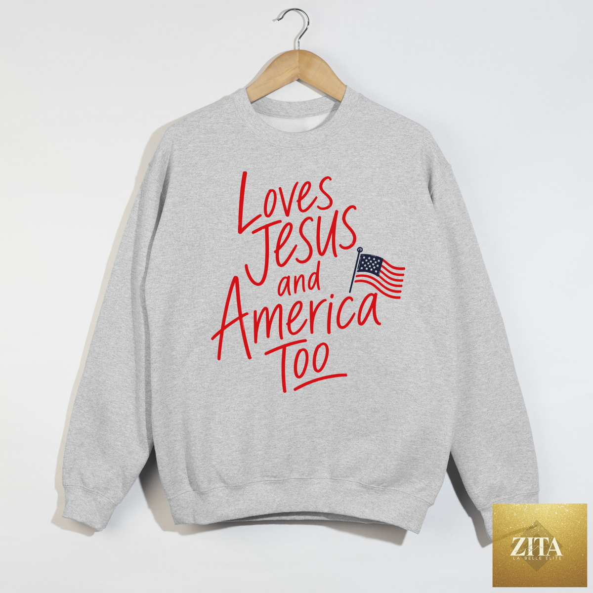 Ash gray patriotic sweatshirt with "Loves Jesus and America Too" graphic from Hey Jude Graphic Tees, casual and comfortable.
