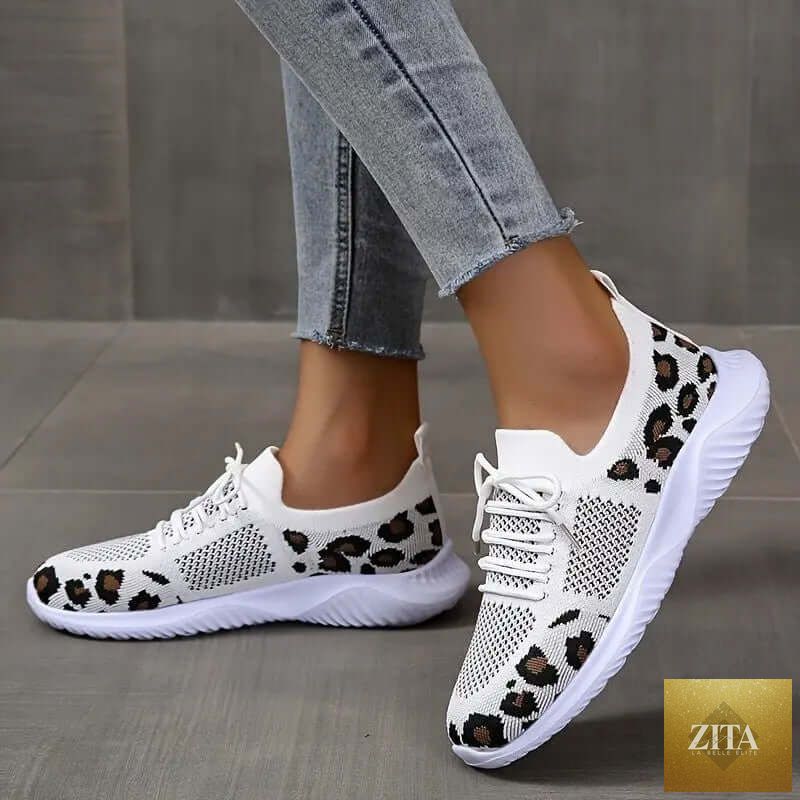 White women's sneakers with leopard print accents and lace-up design from SnagBag, suitable for sports and casual wear.