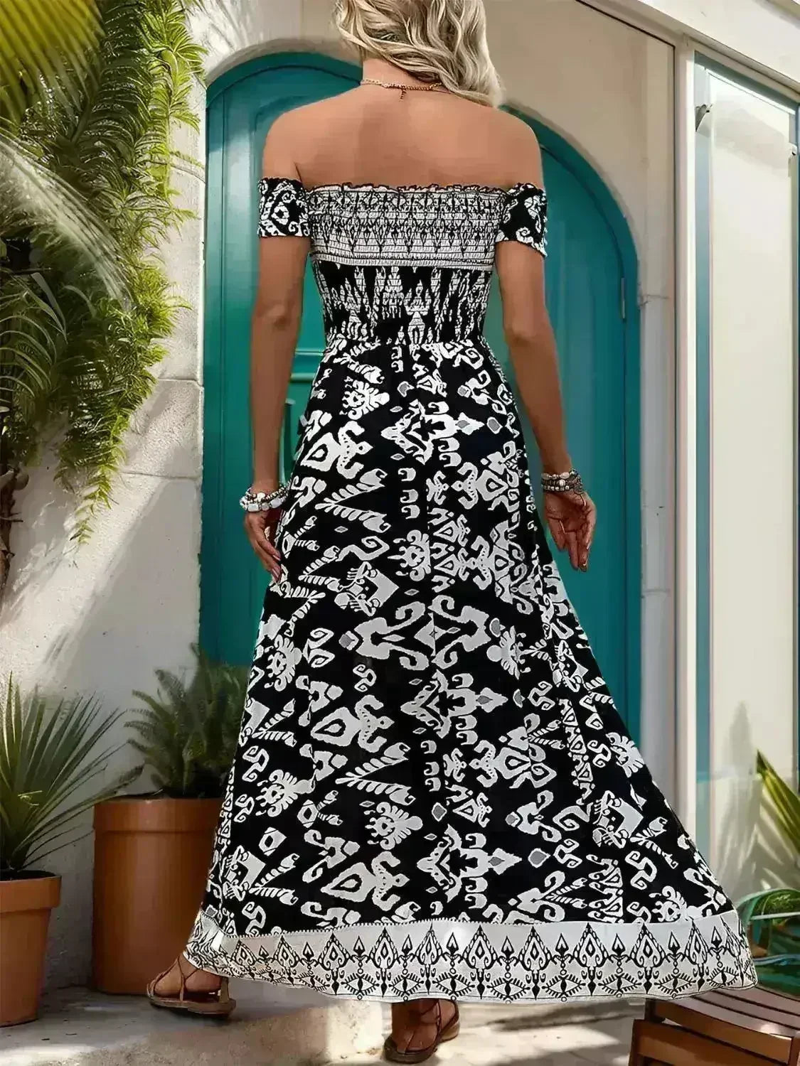 Flowy off-shoulder slit dress for women by Femstylo, featuring a lightweight viscose fabric and elegant draped design.