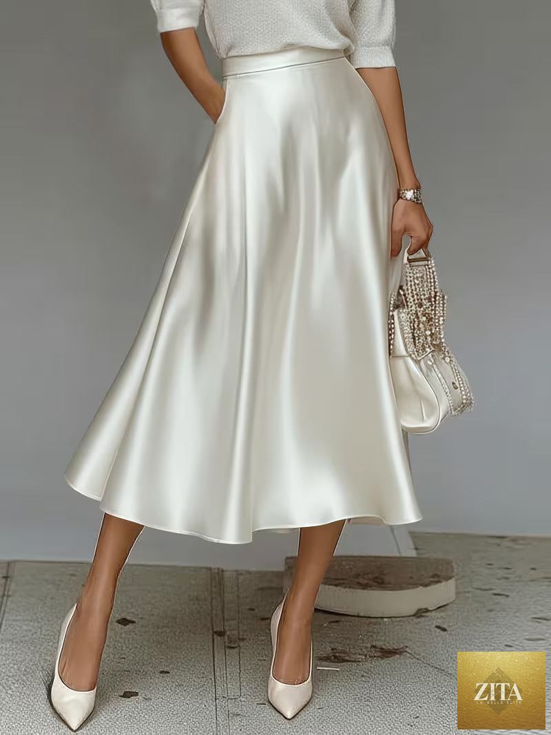 Women's satin solid color mid-length skirt by Zita La Belle Elite, featuring a slight stretch fabric and smooth, shiny finish.
