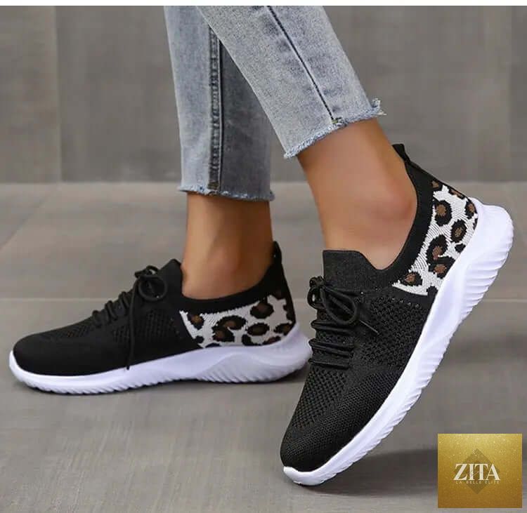 White women’s leopard print lace-up sneakers from SnagBag, sporty shoes with stylish animal print detail.
