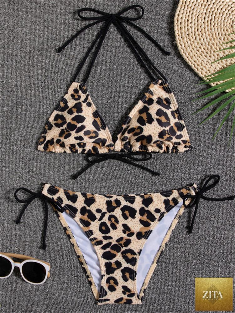 Sunset Bloom Stevvex women's two-piece bikini set with vibrant floral print, tie-back top, and high-cut tie-side bottoms on a model.