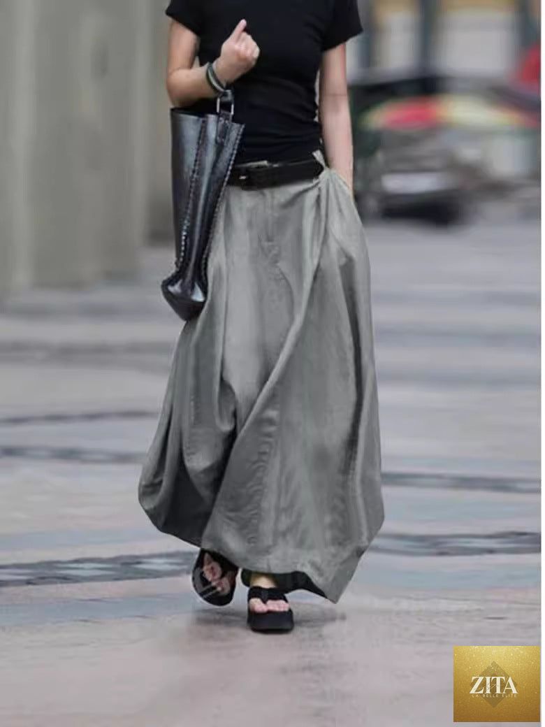 Women's high-waist flared maxi skirt in solid cotton linen with pockets, by FitiqueFit, showing the flowing silhouette and pocket details.