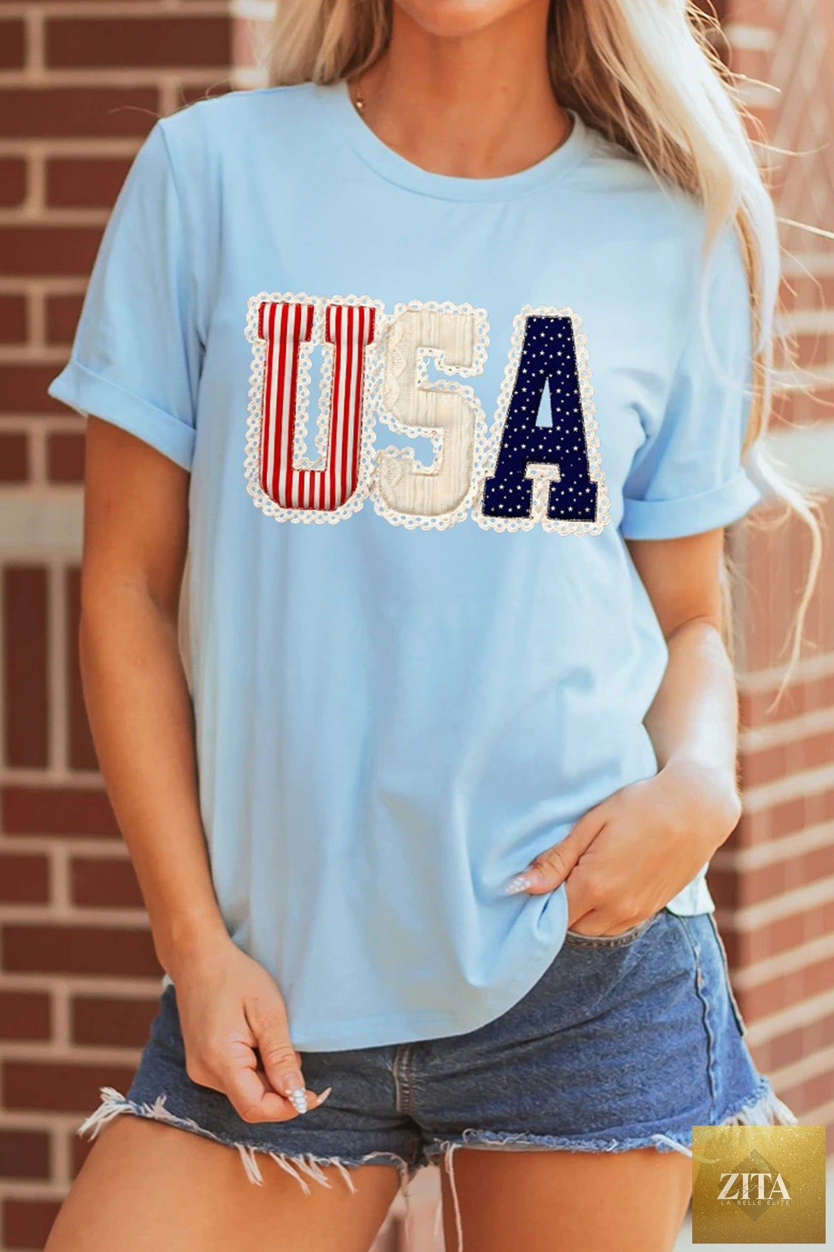 Light blue USA patriotic graphic T-shirt from Wild and Free Boutique featuring patriotic print and casual fit.