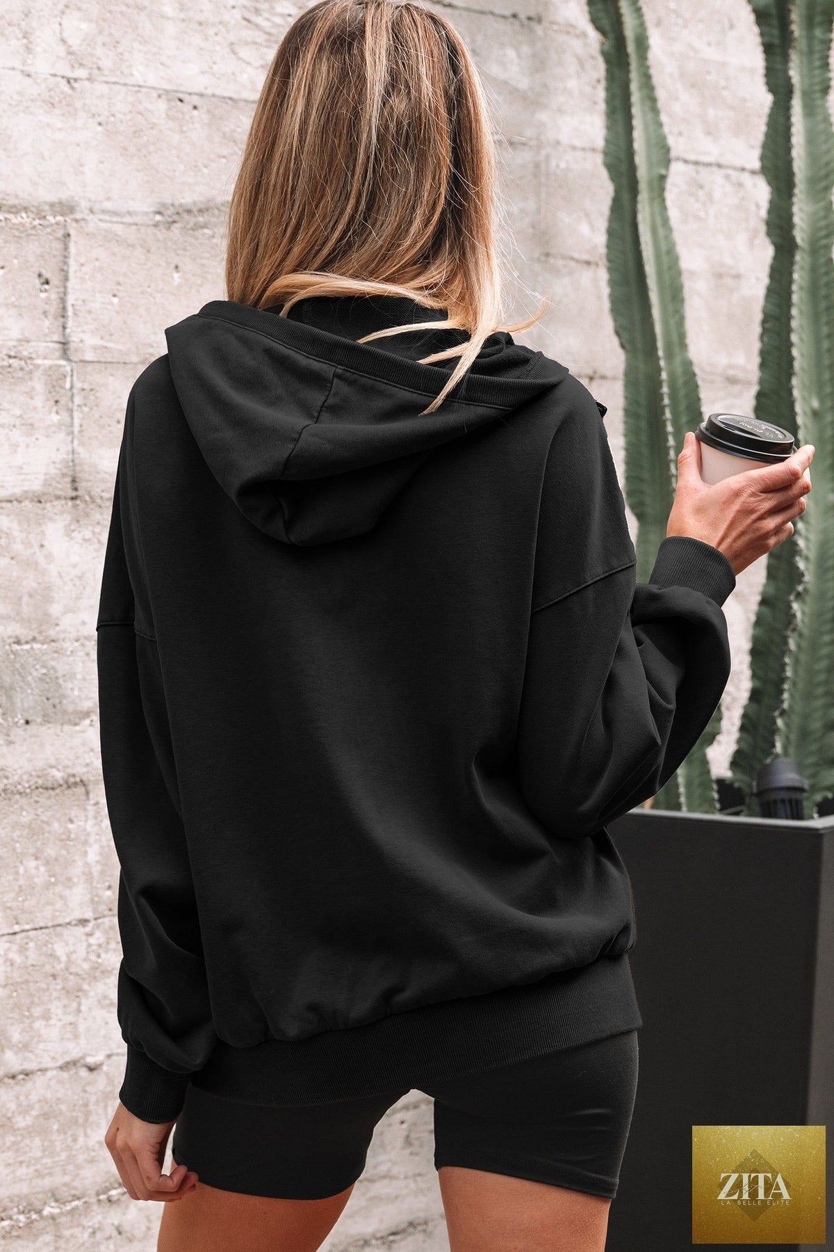 Black half zip kangaroo pocket mineral wash hoodie from Wild and Free Boutique, featuring a relaxed baggy fit and casual style.