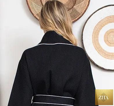 Back view of Lotus Linen women's black waffle piping bathrobe with small piping details, lightweight spa-style comfort.