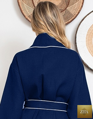 Back view of navy knee-length waffle robe for women by Lotus Linen, featuring piping details and a cozy, textured fabric.