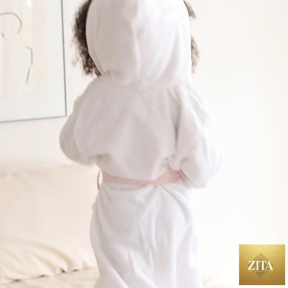 Pink kids plush robe by Lotus Linen, ultra-soft and cozy for toddlers, shown from the back with small size and plush fabric.
