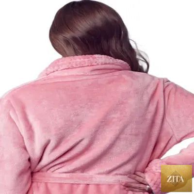Back view of a small pink Lotus Linen women's ultra soft plush bathrobe hanging on a hook.