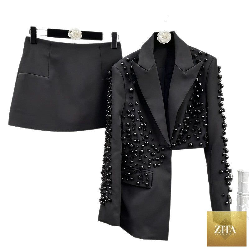 Zita La Belle Elite women's beaded blazer and skirt outfit featuring a deep V-neck and intricate detailing on the fabric.