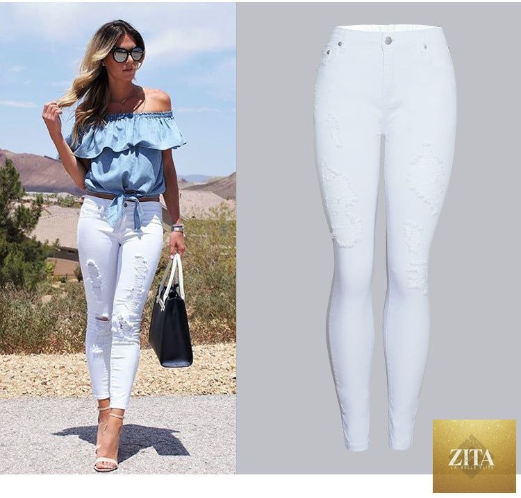 White women's slim-fit skinny pants with ripped details, trendy solid-color design, shown on a model.