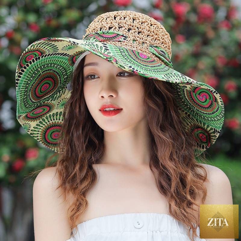 Women's patterned straw beach sun hat with round crown and wide brim, providing UV protection, by Zita La Belle Elite.