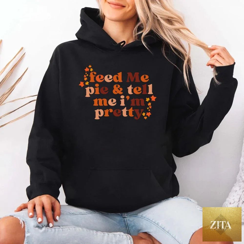 Black hoodie from Adorb Custom Tees with "Feed Me Pie And Tell Me I'm Pretty" print, casual fall fashion hoodie.