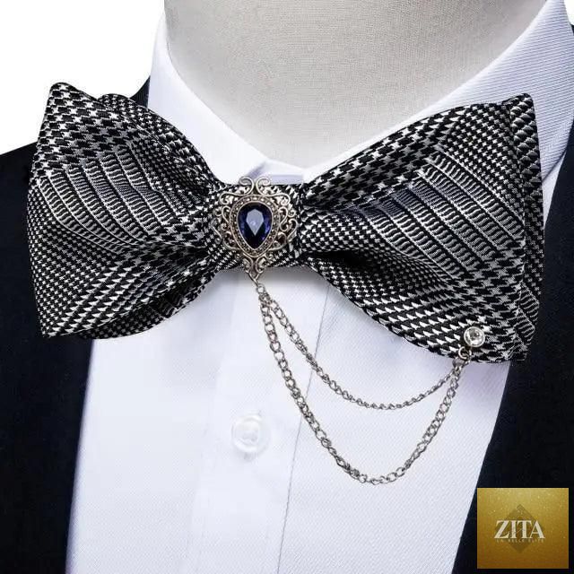 Elegant black and gold patterned silk bowtie and pocket square set for men, perfect for weddings and formal business attire.