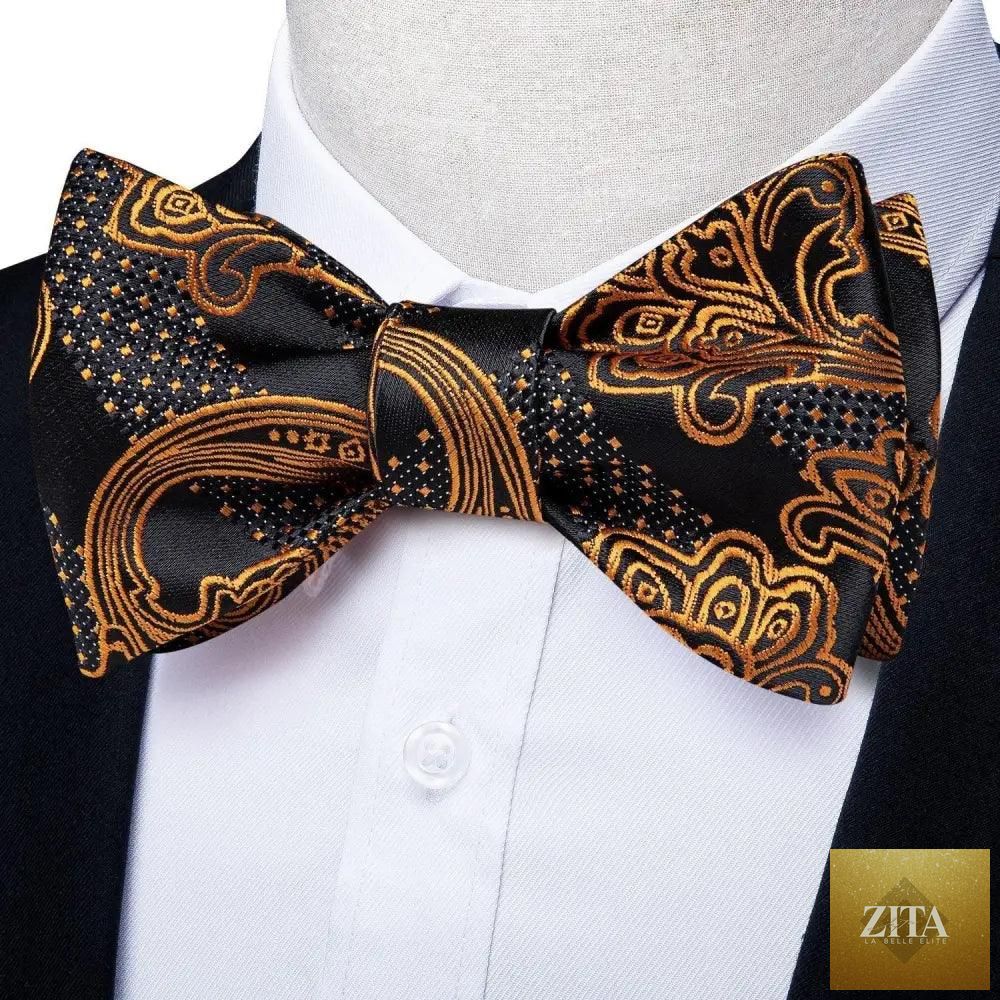 Elegant gold and black patterned silk bowtie and pocket square set for men, suitable for wedding and formal tuxedo attire.
