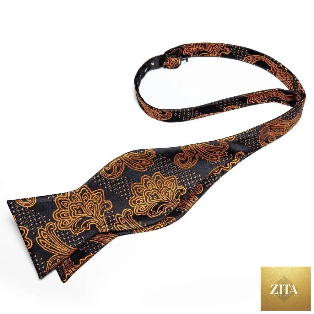Elegant gold and black patterned silk bowtie and handkerchief set for men, perfect for wedding or formal business attire.
