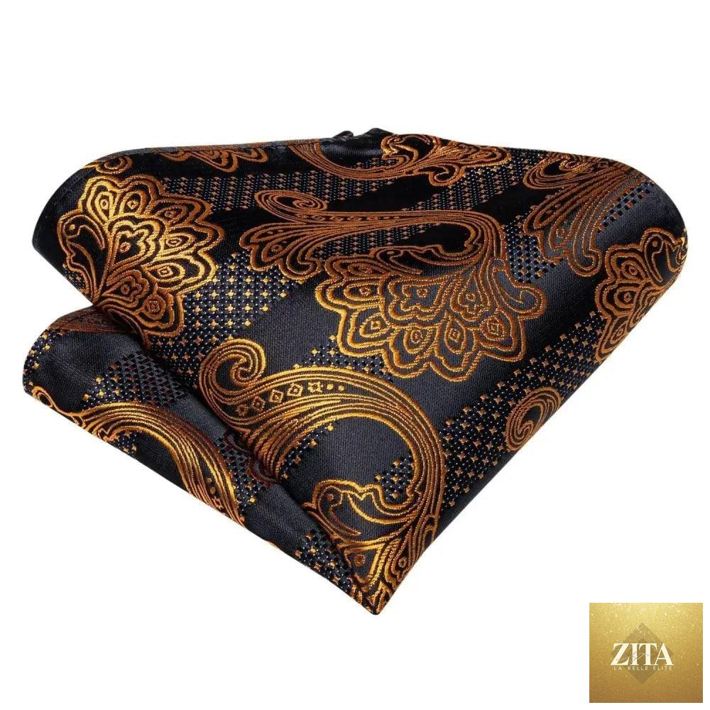 Elegant gold and black patterned silk bowtie with matching pocket square, ideal for wedding or formal business attire.