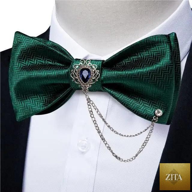 Elegant black and gold patterned silk bowtie with matching pocket square, perfect for wedding or formal business attire.