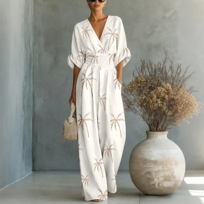 Women’s waist-cinched V-neck printed wide-leg jumpsuit by FitiqueFit, showcasing a casualwear style with a relaxed fit and stylish pattern.