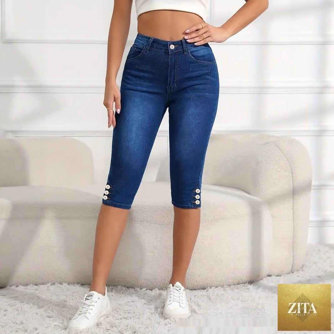 Plus-size women's slim-fit Capri pants in versatile style, shown in a neutral color with a close-up view of the fabric and fit.