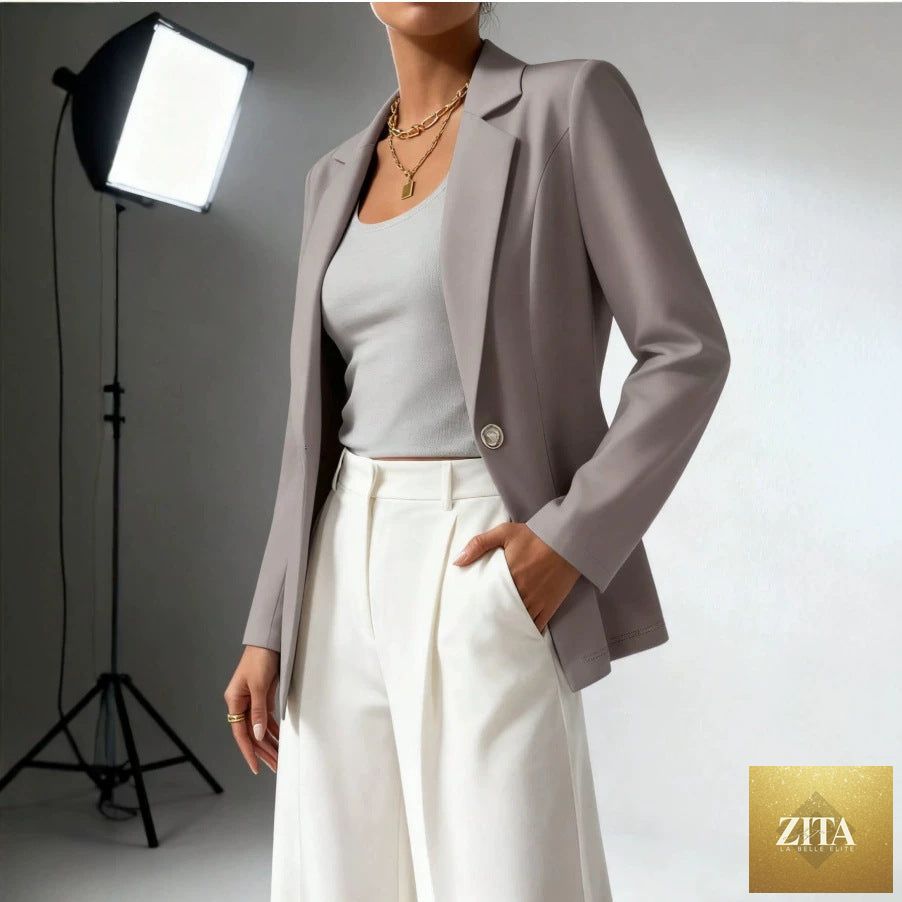Women's slim fit blazer by FitiqueFit with lapel collar, long sleeves, and waist-cinched design, styled for a tailored look.