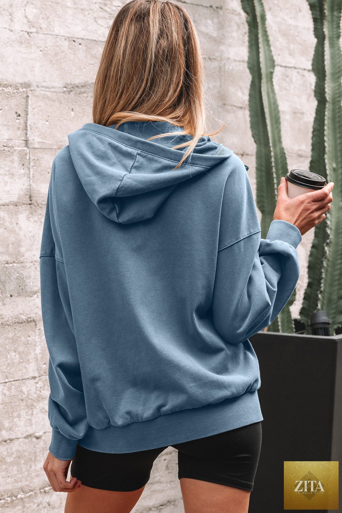 Black half zip hoodie with kangaroo pocket and mineral wash finish, from Wild and Free Boutique, perfect for casual wear.