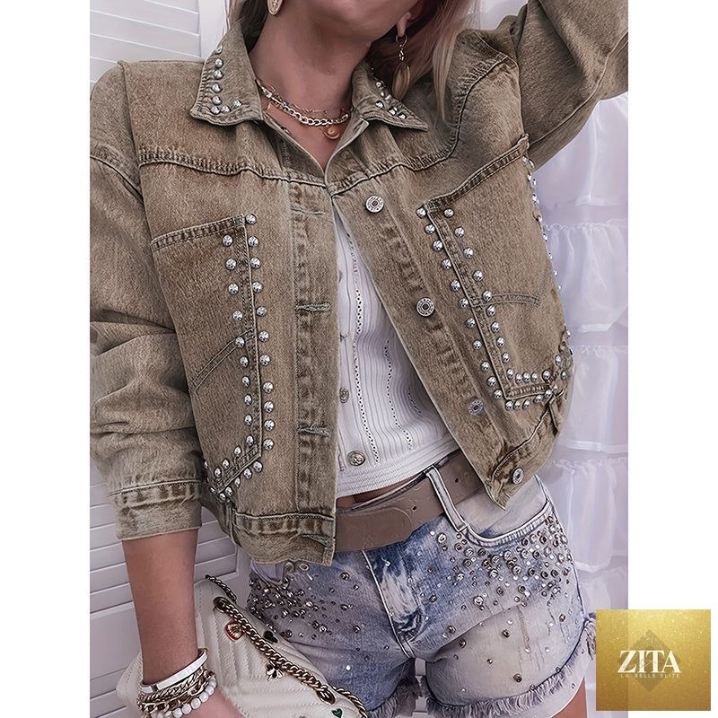 Women’s studded denim jacket by FitiqueFit featuring silver studs on classic blue denim with front pockets and button closure.