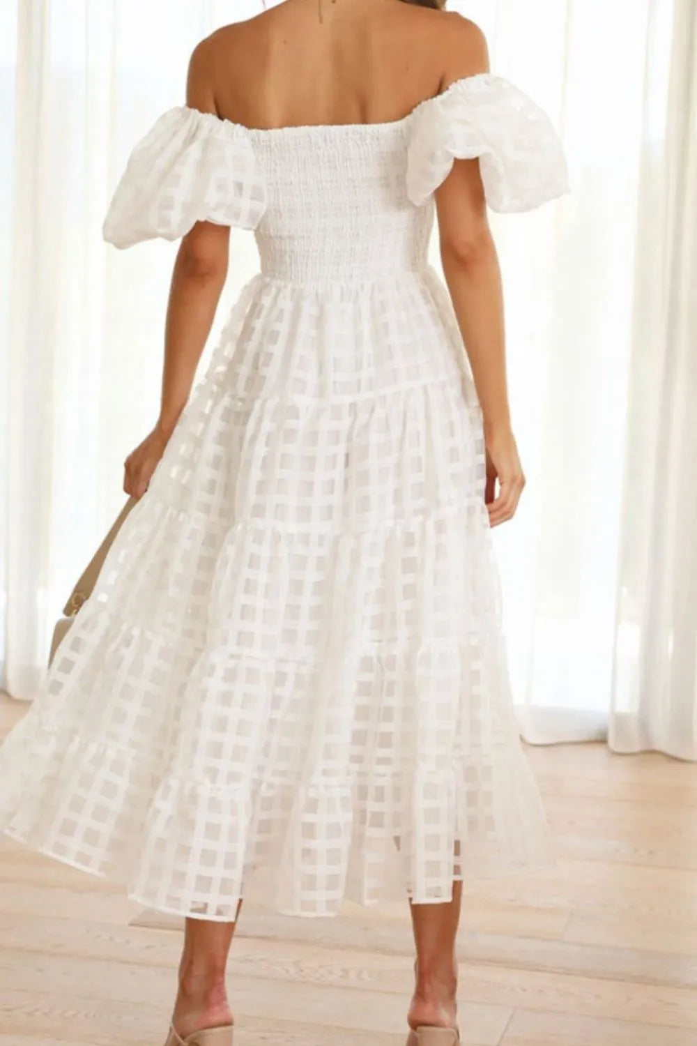 Off shoulder short puff sleeve midi dress by Shopiebay, featuring a stylish design with a fitted bodice and flowing skirt.