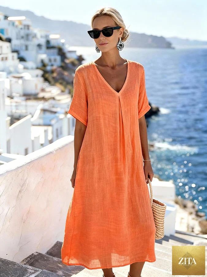 Patchwork asymmetrical maxi dress by FitiqueFit featuring a relaxed V-neck style and flowing silhouette with colorful patchwork details.