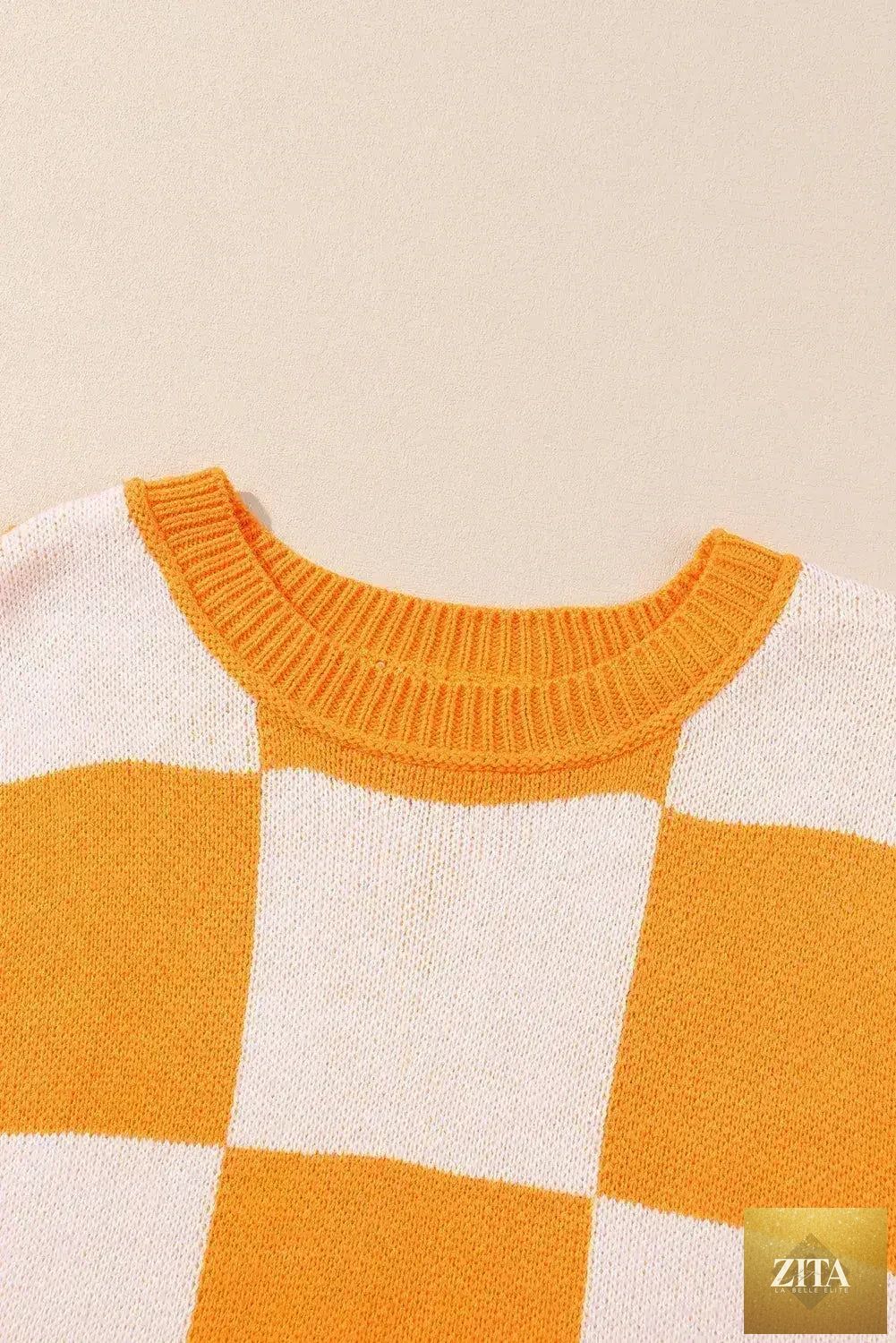 Orange checkered Femstylo bishop sleeve sweater with ribbed cuffs and neckline, featuring a cozy, stylish knit design.