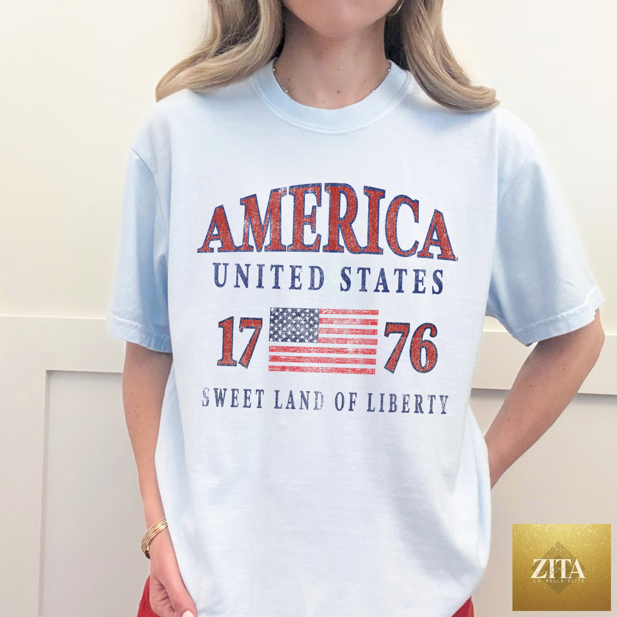Light blue America 1776 graphic T-shirt from Hey Jude Graphic Tees featuring patriotic USA design on chambray fabric.