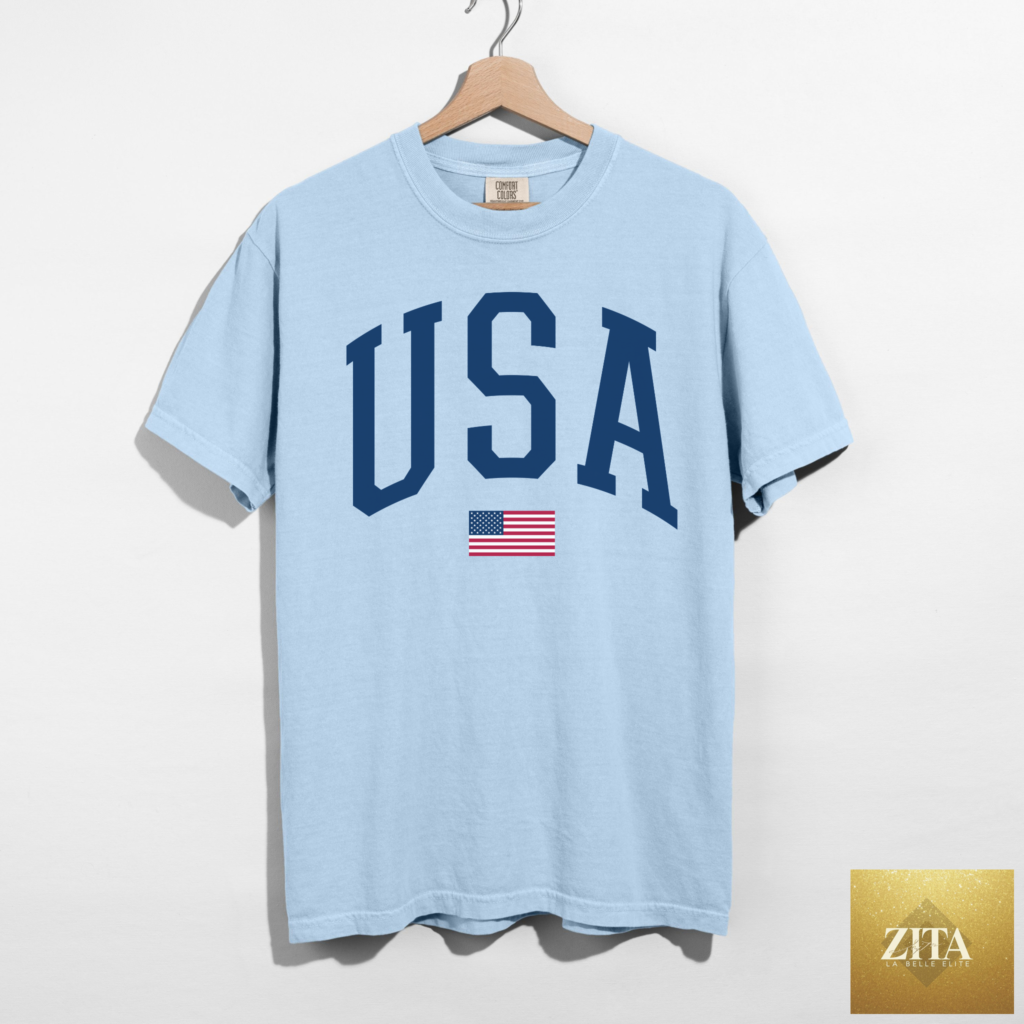 Blue chambray USA Varsity Graphic Tee by Hey Jude Graphic Tees featuring patriotic patriotic design and classic American style.