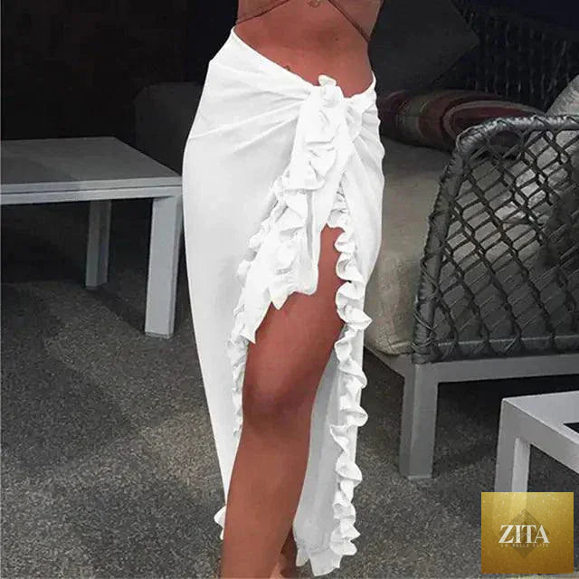 Mandotos GlamourWave chiffon beach wrap draped over a woman, showcasing lightweight, elegant fabric perfect for sunny beach days.