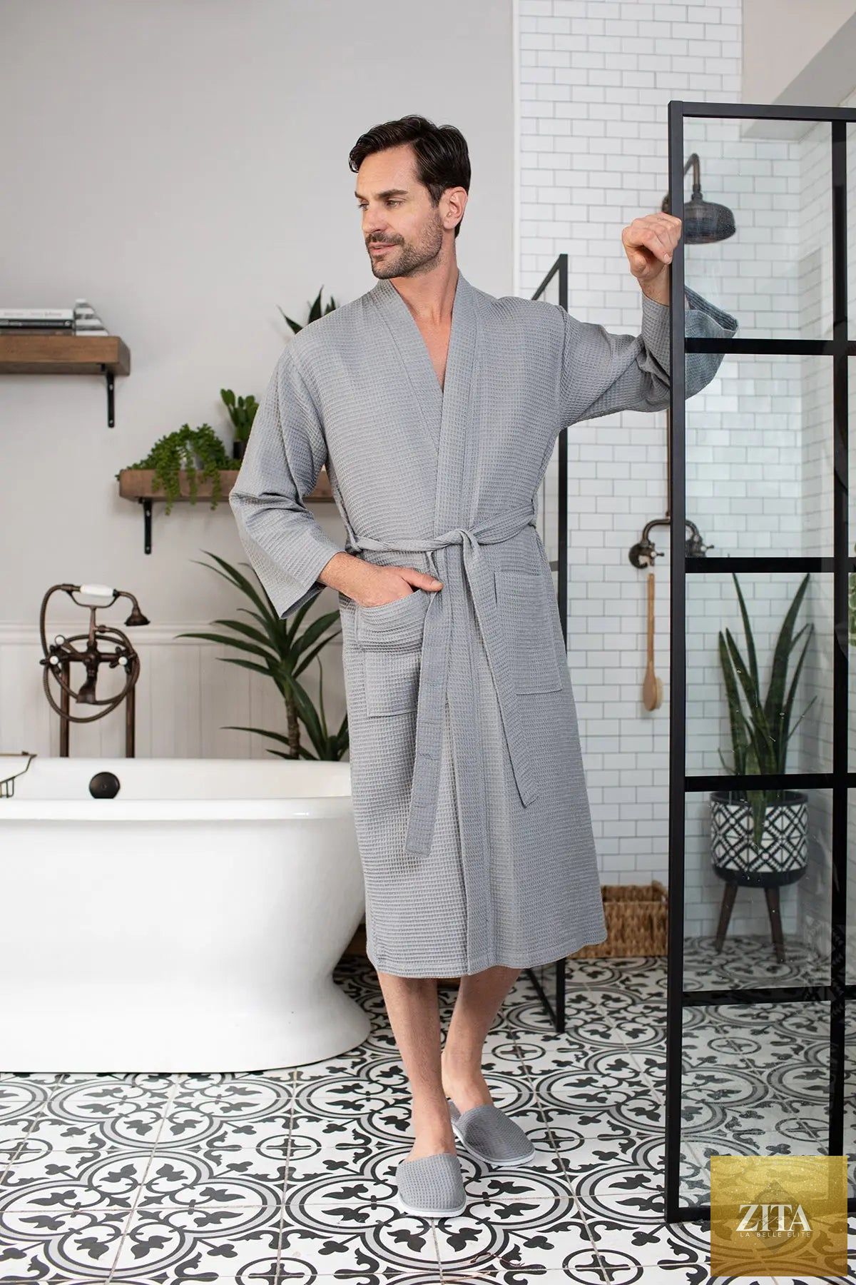 Cotton waffle spa bathrobe for men by Lotus Linen, lightweight and absorbent, shown hanging on a hook.