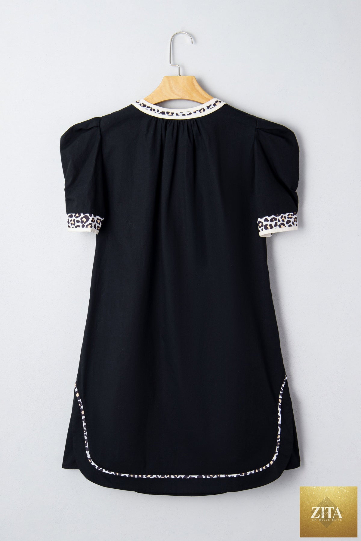 Black leopard trim short puff sleeve shift mini dress from Wild and Free Boutique, featuring a notched neckline and stylish design.