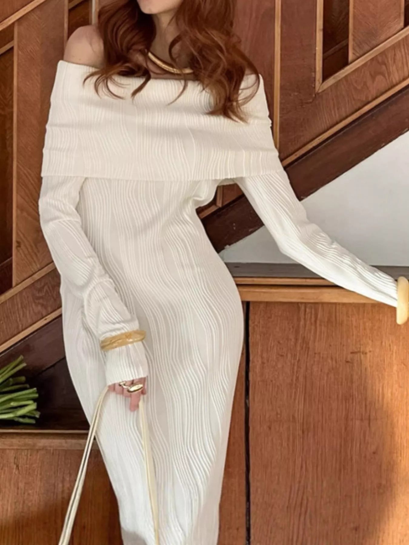 Off-shoulder textured knit maxi dress by Shopiebay featuring a flowing silhouette and long sleeves in soft fabric.