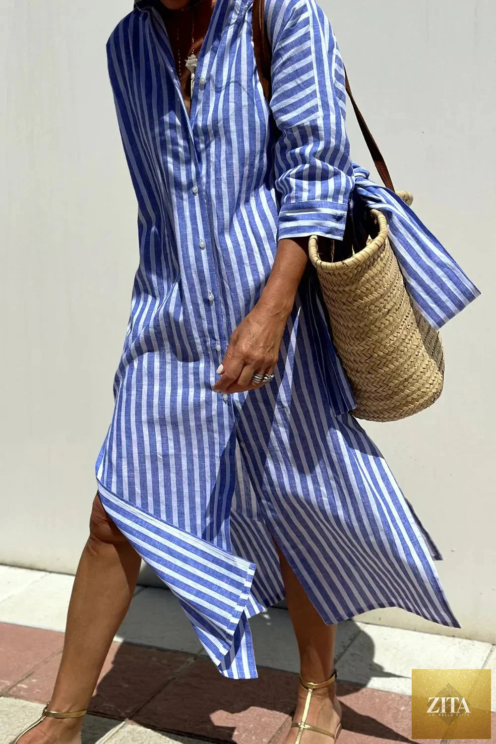 Tied button-up three-quarter sleeve dress by Shopiebay, featuring a stylish design with a tie waist and three-quarter sleeves.
