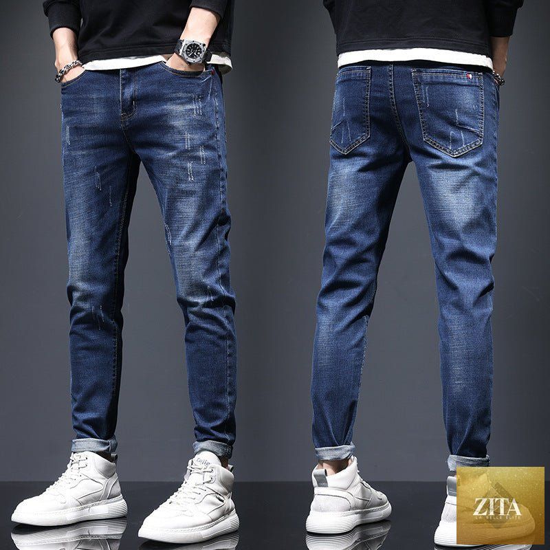 Mandotos men's ripped denim jeans with cat-whisker scratch details, showcasing distressed fabric and classic five-pocket style.