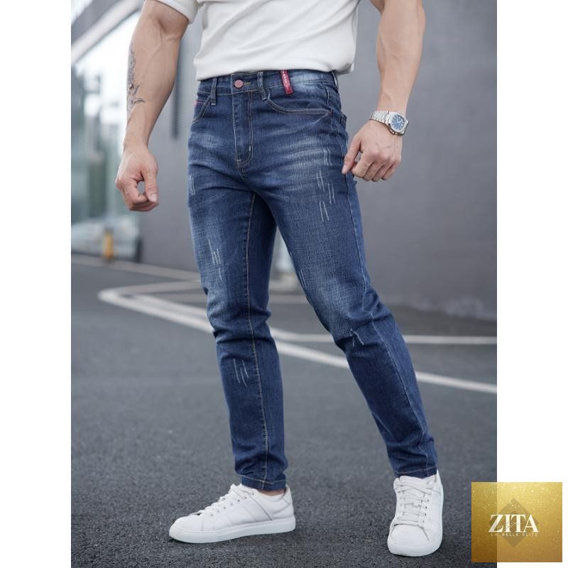 Mandotos men's ripped denim jeans with distressed cat-whisker scratches, showcasing a stylish, edgy design and classic denim texture.