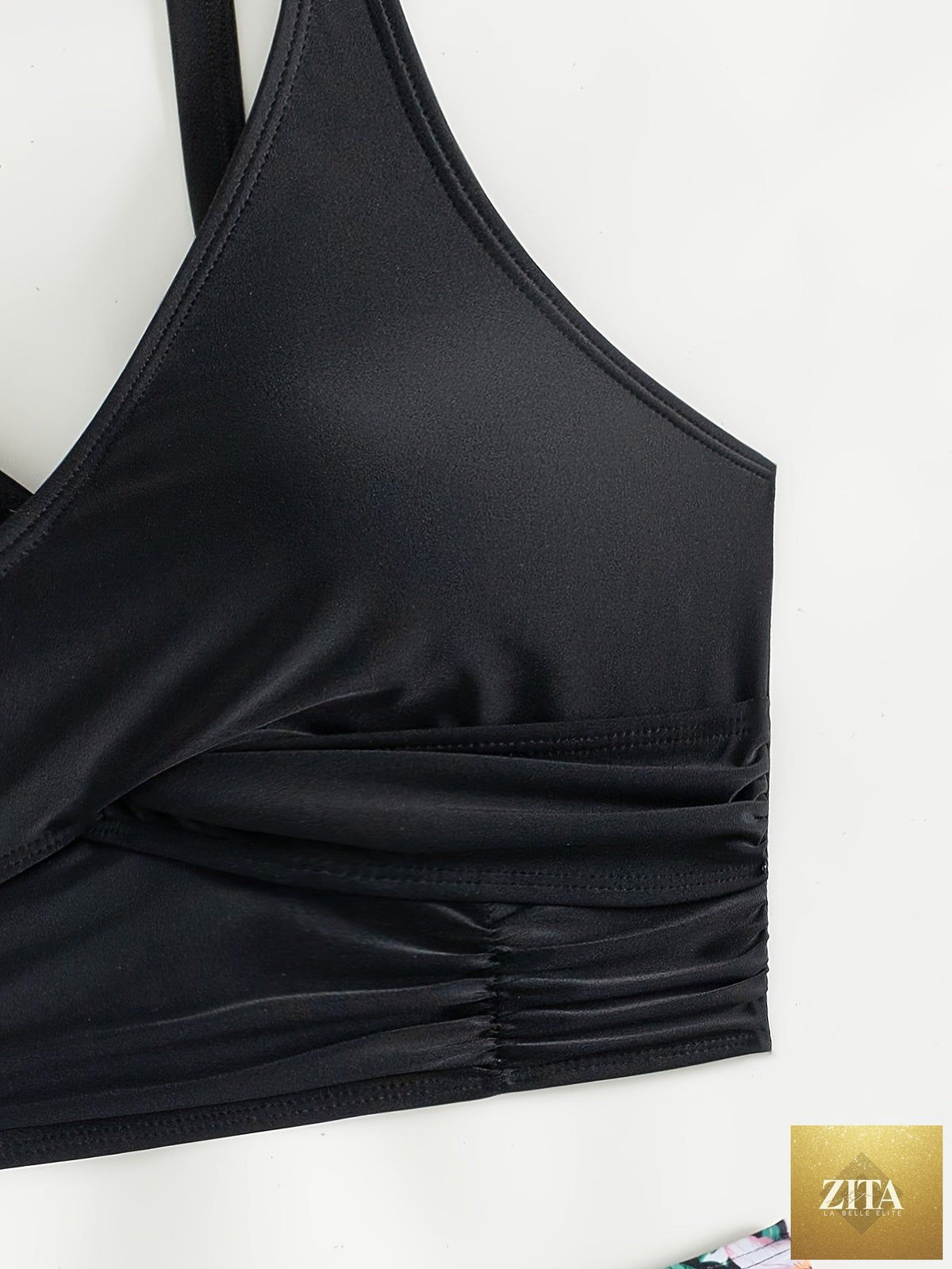 Black Stevvex bikini set with twist front, high waist, ruched tummy control, and cross strap detail, made of quick-drying stretch polyamide.