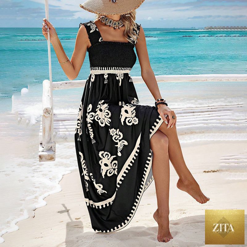 Women's wide-strap printed maxi dress by MERIDGE with a smocked bodice and tassel waist, featuring a flowing fabric and vibrant pattern.