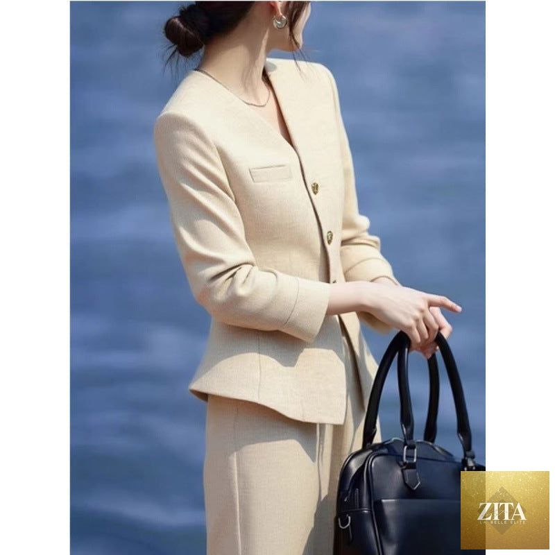 Beige waist-grabbing coat and wide-leg pants set by FitiqueFit, stylish outerwear with a tailored fit and flowing pant design.