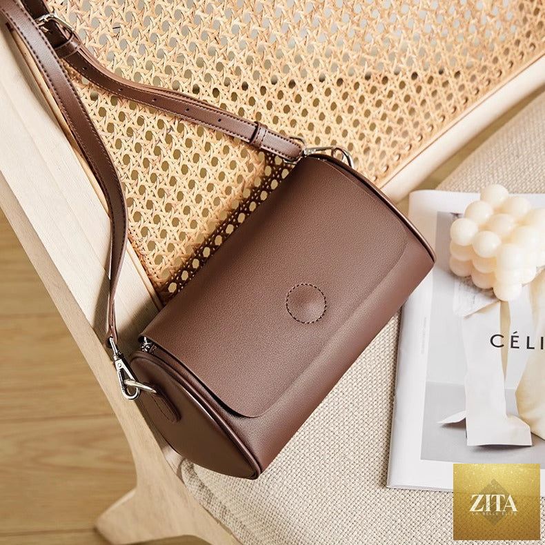 Elegant genuine leather mini round handbag tote for women, featuring a shoulder strap and stylish design.