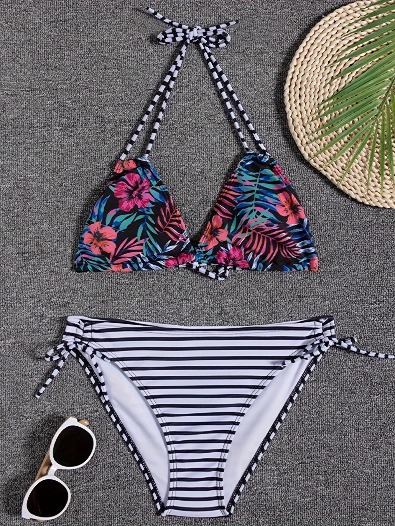 Stevvex Sunset Bloom 2-piece triangle bikini set with vibrant floral print, halter neck, tie-back, and high-cut bottoms for women.
